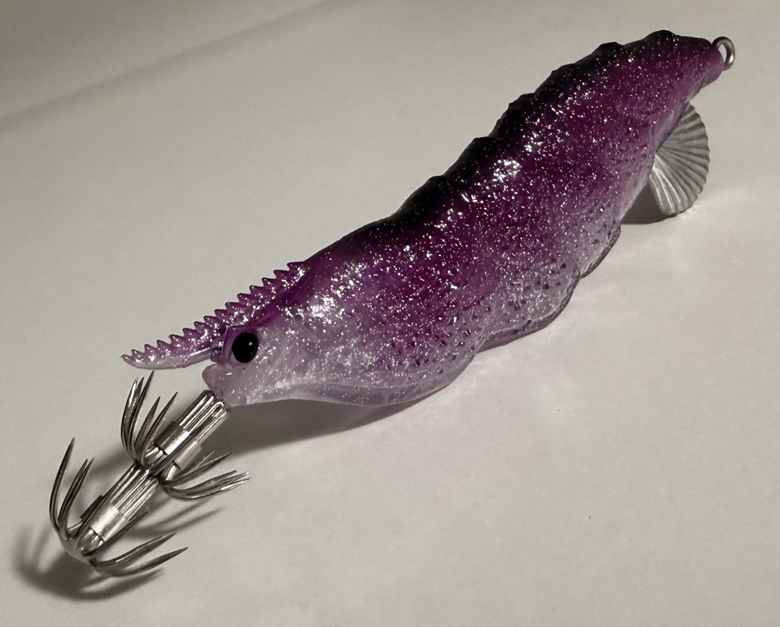 Tafros squid jig in Amethyst Phantom, shot against a studio backdrop